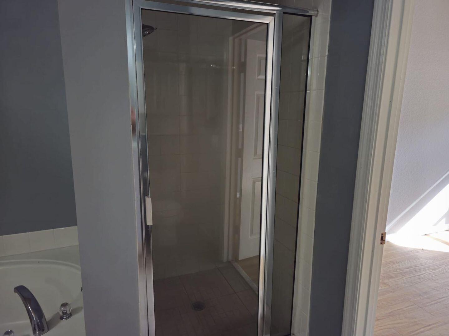 3123 Grandiflora Drive Greenacres, FL 33467 - Photo 27 of 49 a bathroom with a glass door