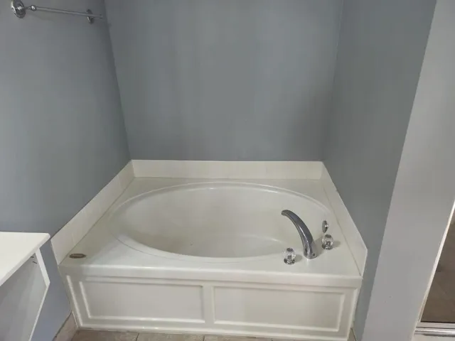 an empty room with wooden floor and closet