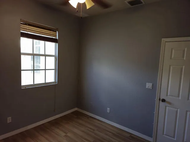a view of hallway with wooden floor