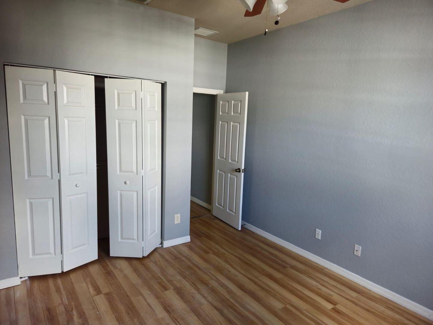 3123 Grandiflora Drive Greenacres, FL 33467 - Photo 35 of 49 a view of an empty room with wooden floor and a window