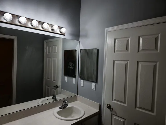 an empty room with wooden floor and a window