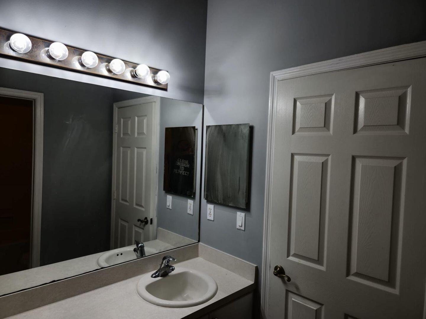 3123 Grandiflora Drive Greenacres, FL 33467 - Photo 39 of 49 a bathroom with a sink a mirror and a shower