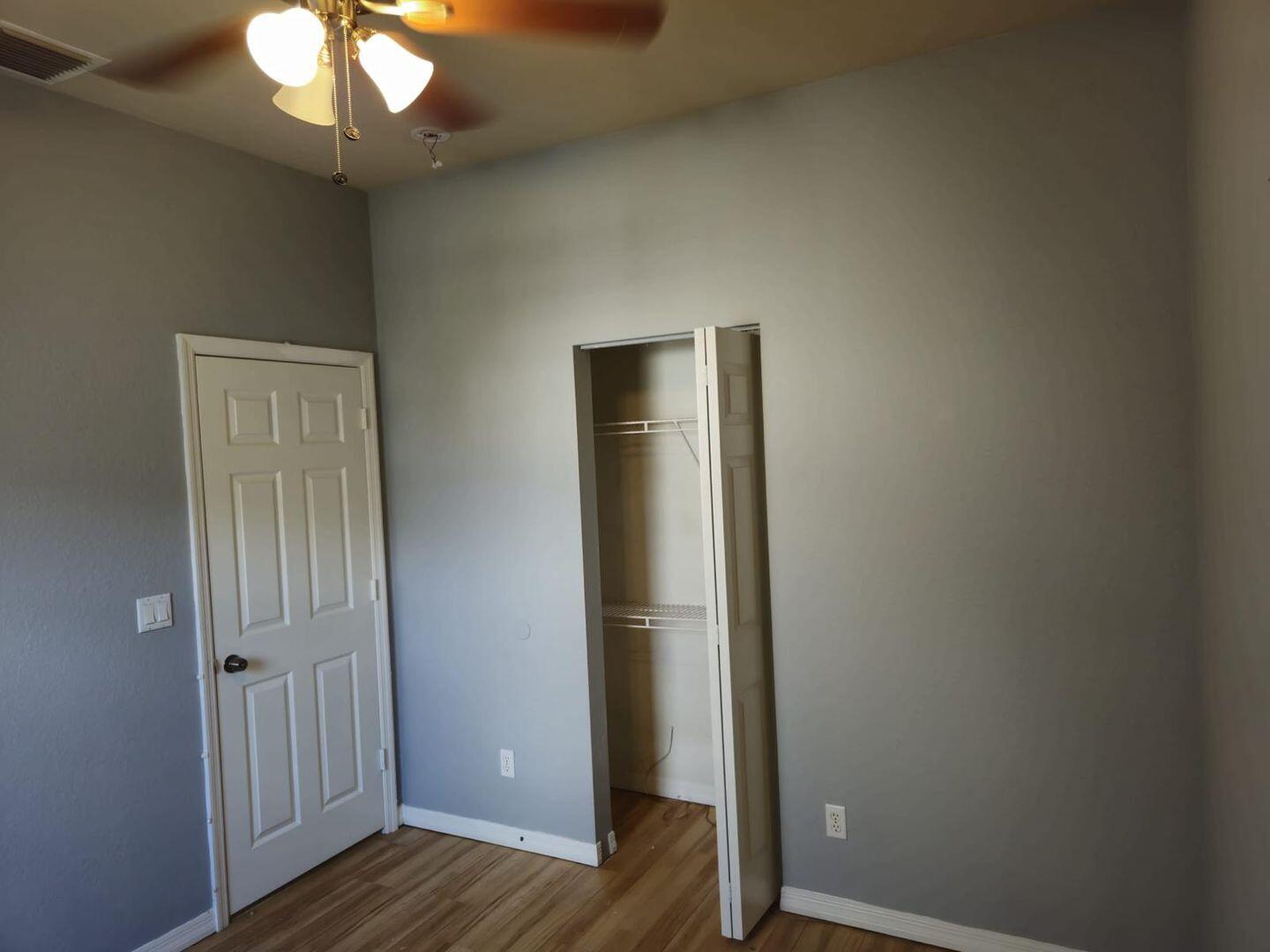 3123 Grandiflora Drive Greenacres, FL 33467 - Photo 41 of 49 an empty room with wooden floor and a window