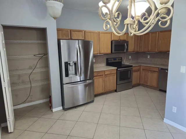 a kitchen with stainless steel appliances a sink stove and refrigerator