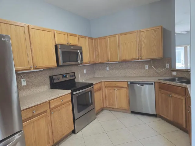 a kitchen with a refrigerator and cabinets