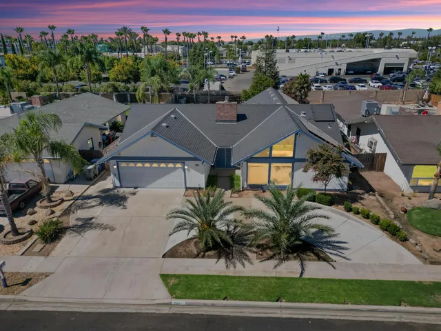 a aerial view of a house with a yard