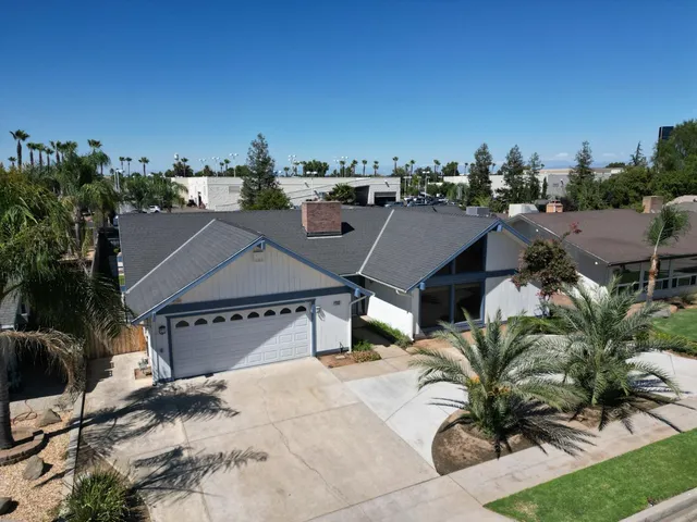 an aerial view of multiple houses with yard