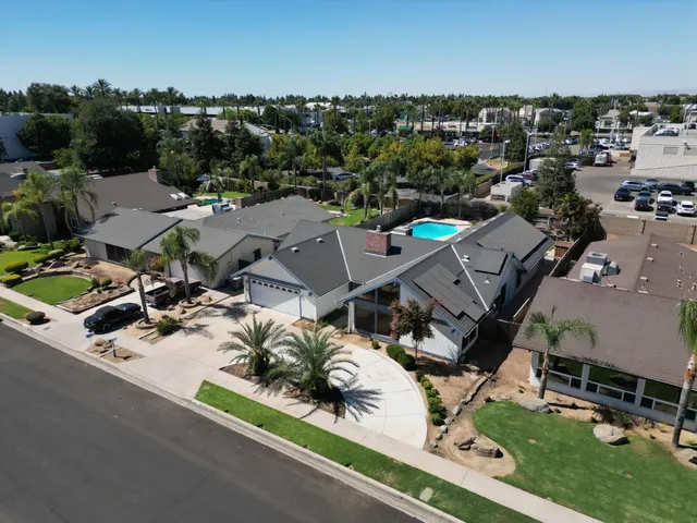 a house with yard and a large parking space