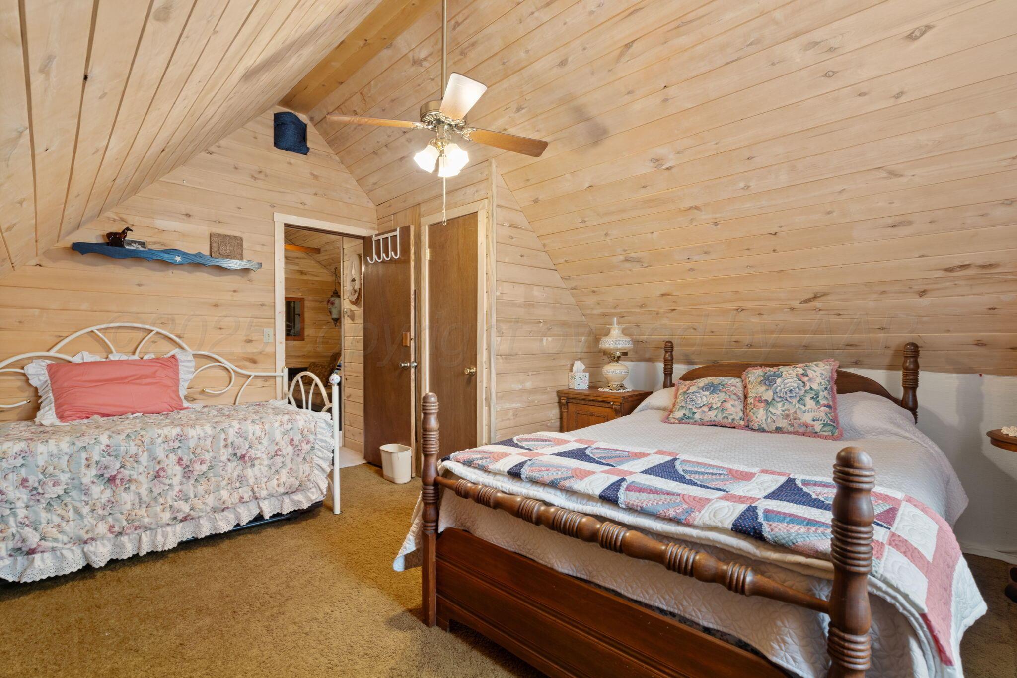 2403 Maple Lane Kingsland, TX 78639 - Photo 11 of 46 a bedroom with a bed and lamp