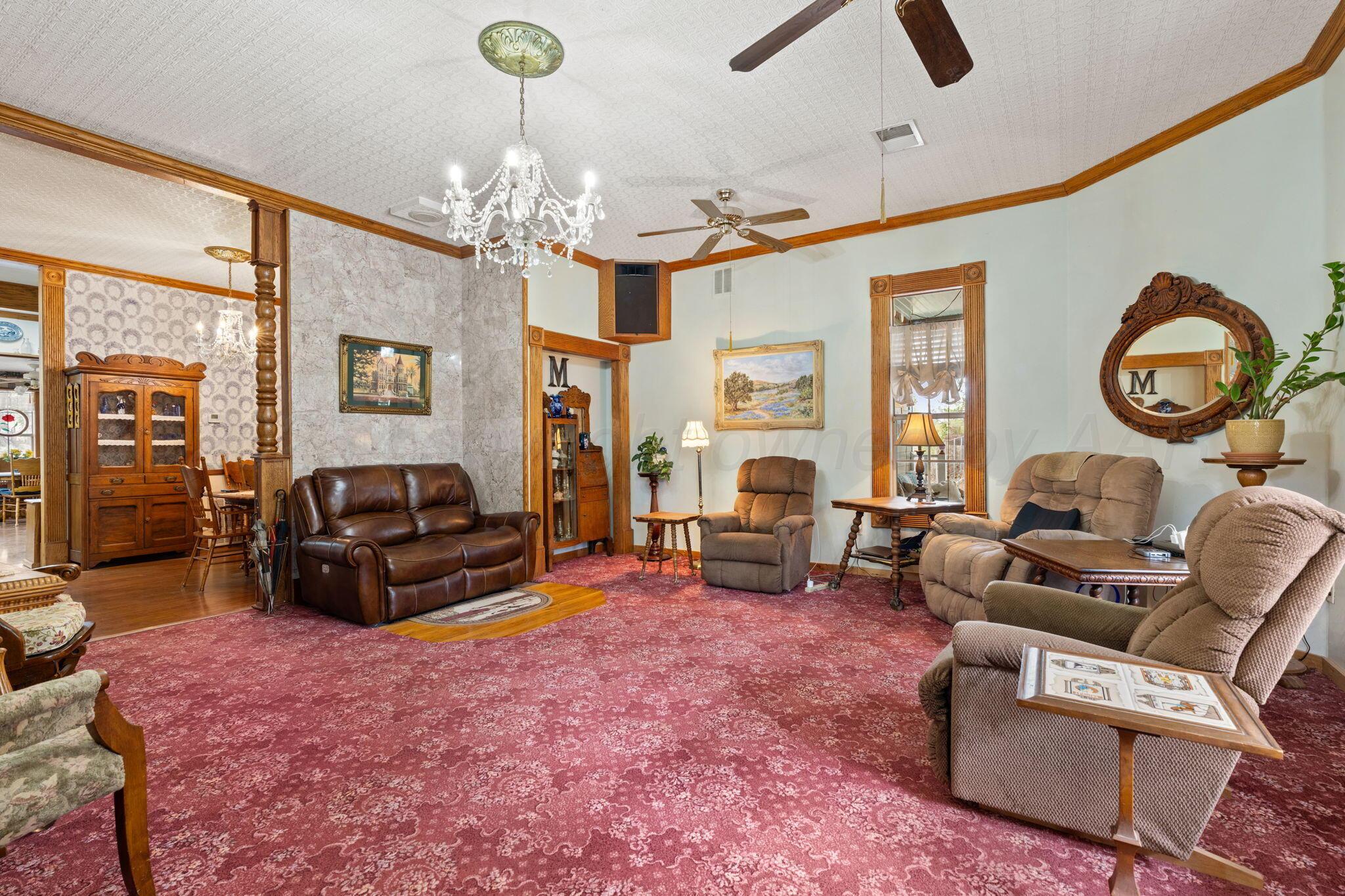 2403 Maple Lane Kingsland, TX 78639 - Photo 14 of 46 a living room with furniture a chandelier and a fireplace