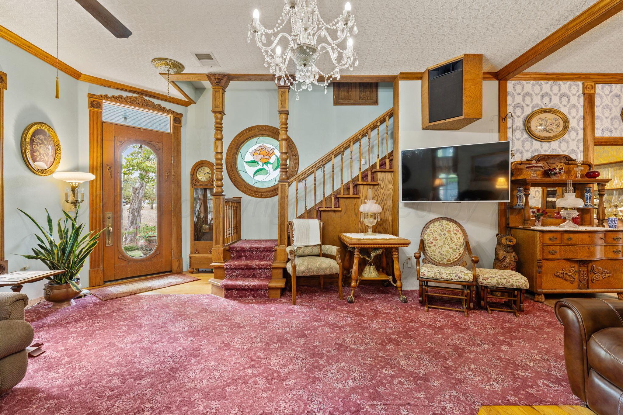 2403 Maple Lane Kingsland, TX 78639 - Photo 15 of 46 a living room with furniture a chandelier and a large window