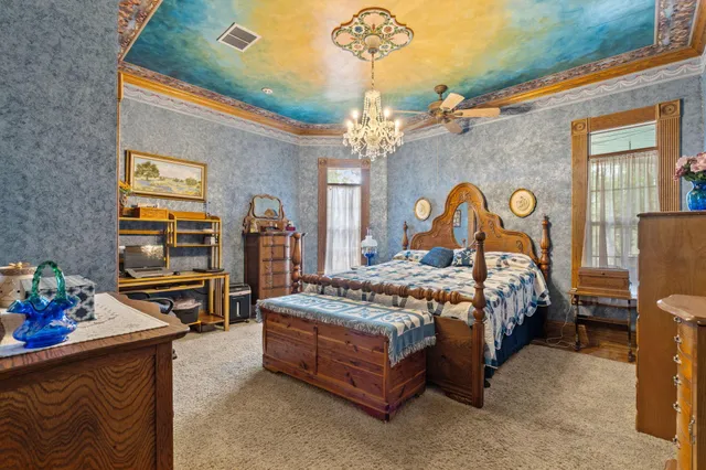a bedroom with a bed and a dresser