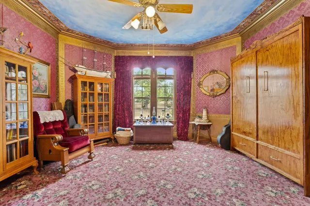 a living room with furniture a rug and a chandelier