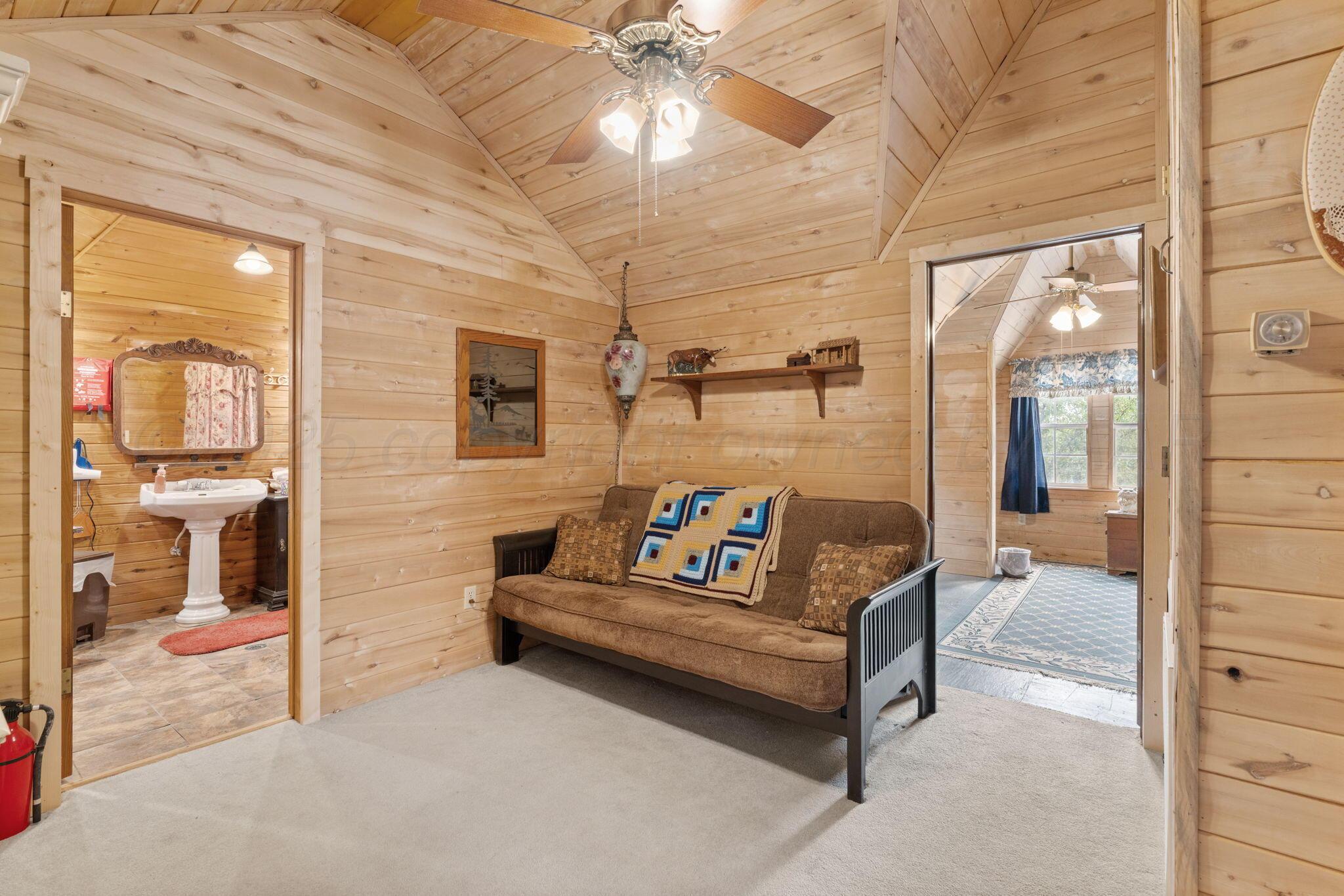 2403 Maple Lane Kingsland, TX 78639 - Photo 4 of 46 a bath room with a couch and a ceiling fan