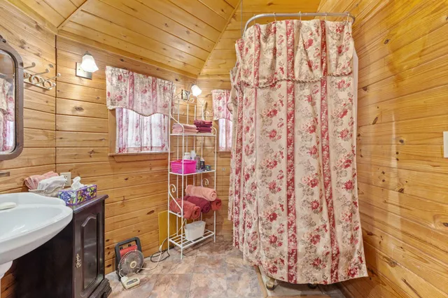 a bathroom with a sink and a shower curtain