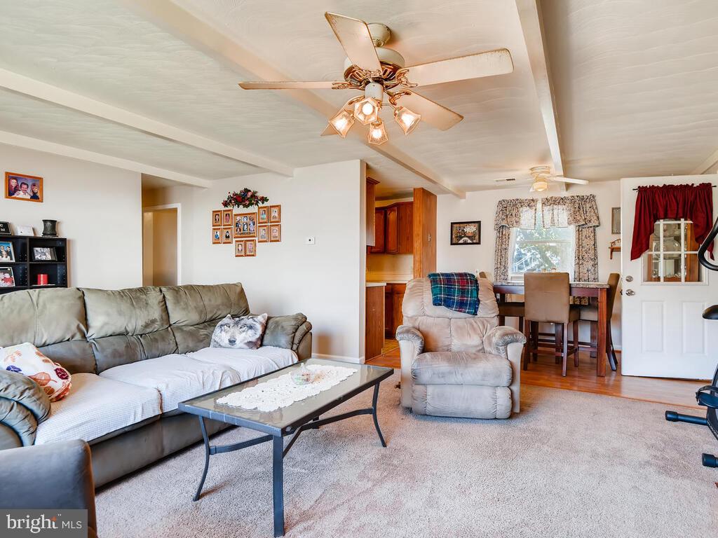 7003 River Drive Road Sparrows Point, MD 21219 - Photo 3 of 19 a living room with furniture and a chandelier
