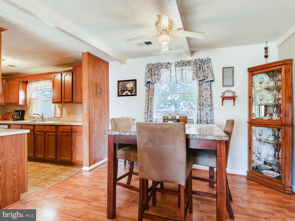 7003 River Drive Road Sparrows Point, MD 21219 - Photo 5 of 19 a dining room with a wooden table and chairs