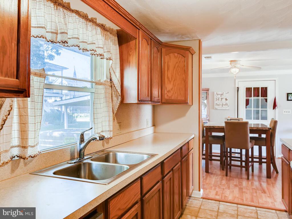 7003 River Drive Road Sparrows Point, MD 21219 - Photo 7 of 19 a kitchen with stainless steel appliances granite countertop a sink and cabinets