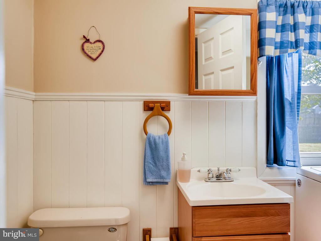 7003 River Drive Road Sparrows Point, MD 21219 - Photo 8 of 19 a bathroom with a sink vanity mirror and toilet