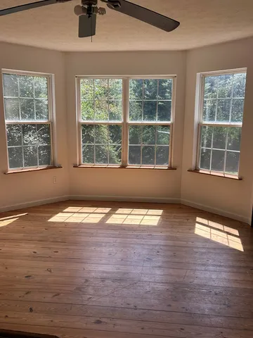a view of empty room with large windows