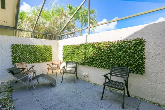 a balcony with table and chairs