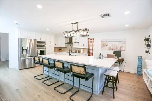 a kitchen with stainless steel appliances granite countertop a sink and stove