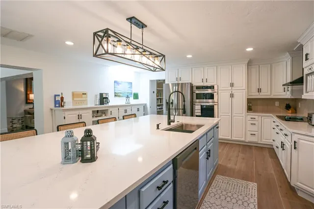 a large kitchen with a table and chairs