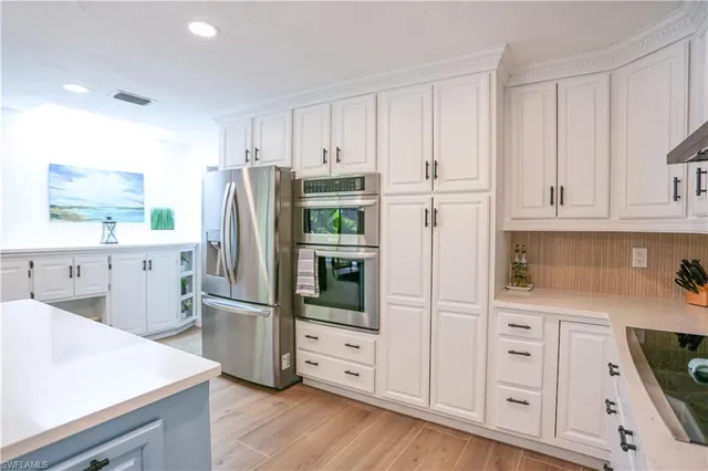 a kitchen that has a lot of cabinets in it