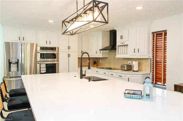 a kitchen with cabinets a sink and appliances