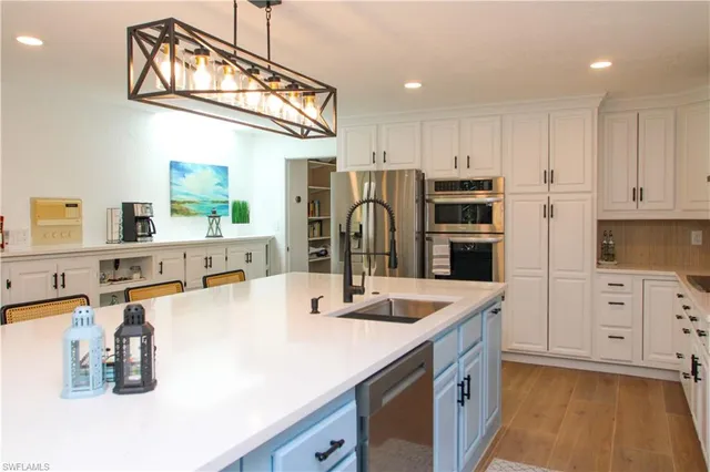 a kitchen with a sink and a stove