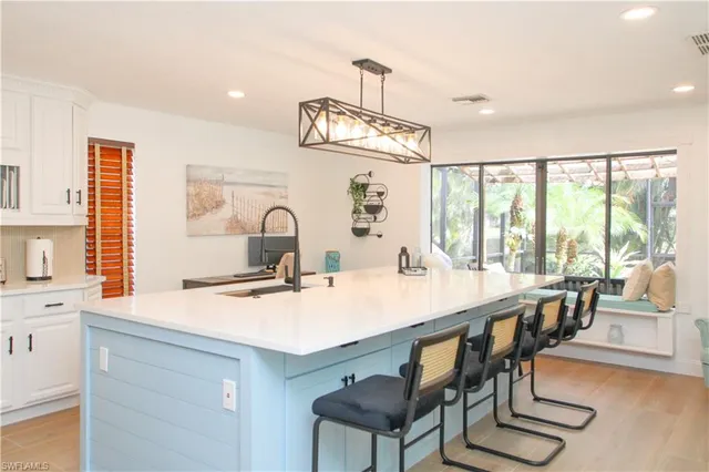 a kitchen with a sink a stove and cabinets