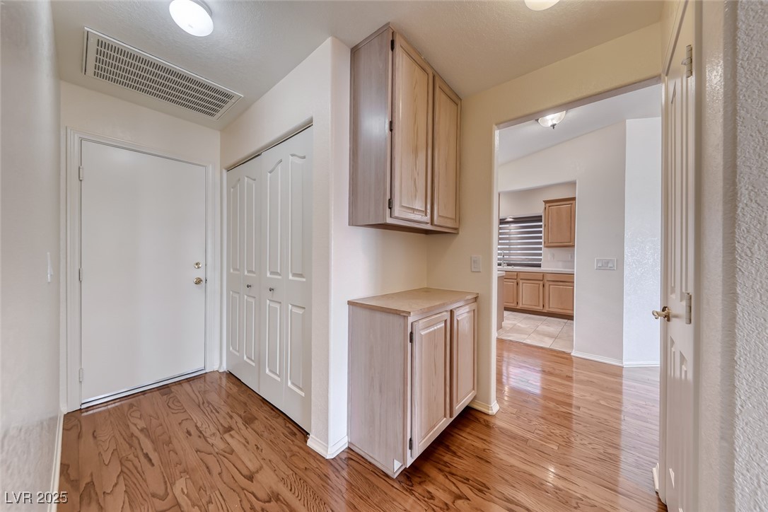 386 Nassau Way Boulder City, NV 89005 - Photo 14 of 44 Hallway featuring light wood-type flooring and baseboards