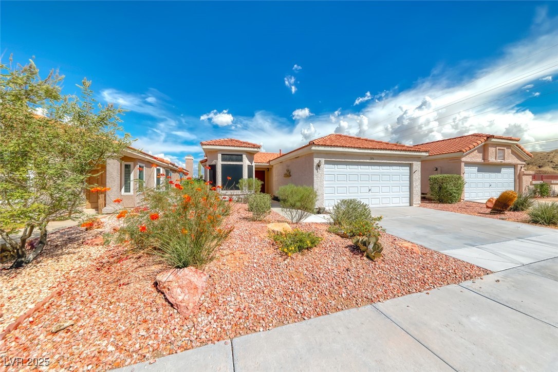 386 Nassau Way Boulder City, NV 89005 - Photo 2 of 44 Mediterranean / spanish house with a tiled roof, stucco siding, concrete driveway, and a garage