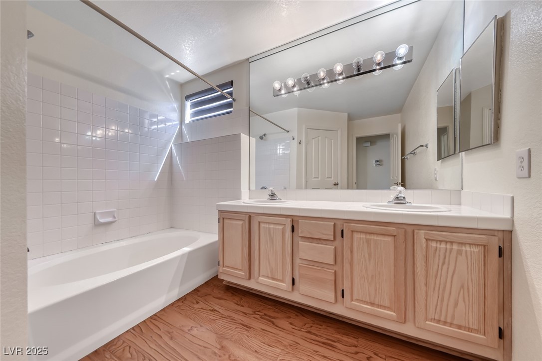 386 Nassau Way Boulder City, NV 89005 - Photo 21 of 44 Bathroom with shower / bath combination, light wood-style flooring, and double vanity