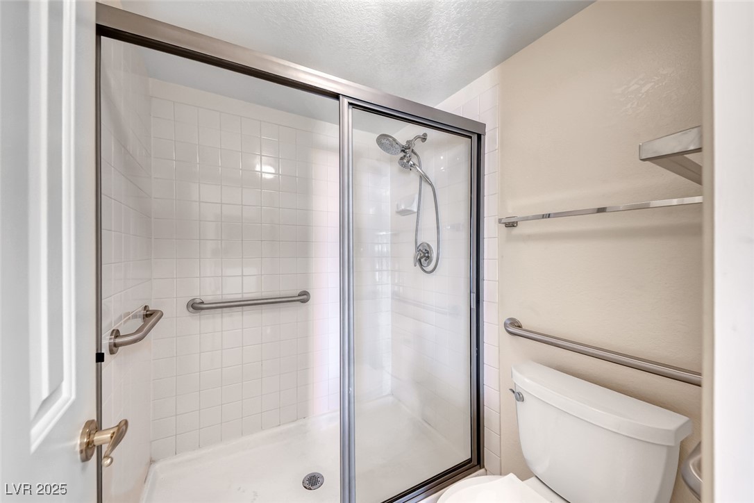 386 Nassau Way Boulder City, NV 89005 - Photo 24 of 44 Bathroom featuring a stall shower and a textured ceiling