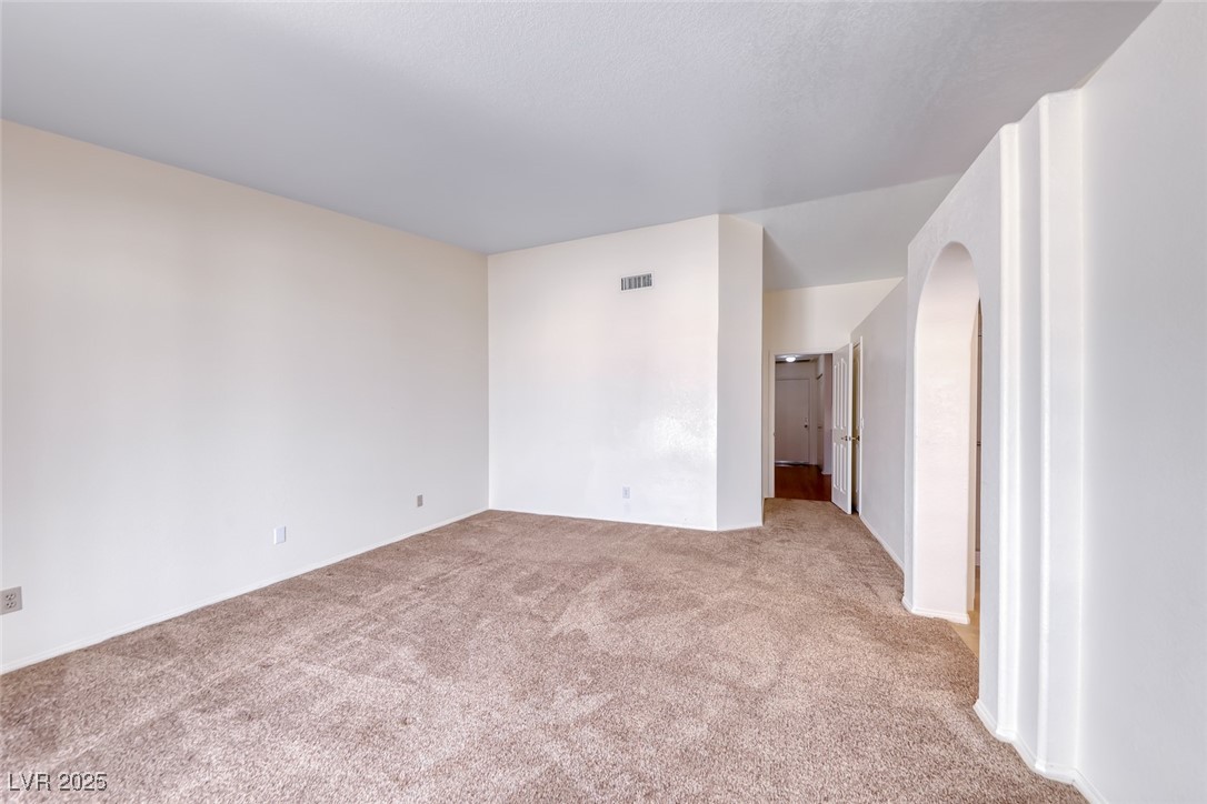 386 Nassau Way Boulder City, NV 89005 - Photo 28 of 44 Unfurnished bedroom with light carpet and arched walkways