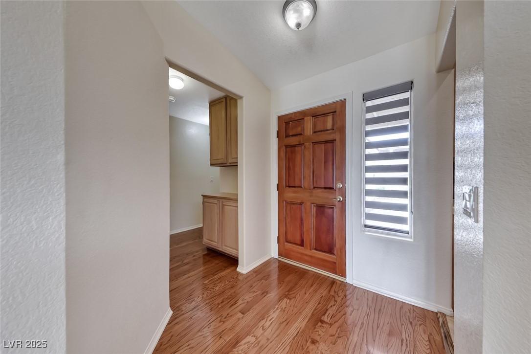 386 Nassau Way Boulder City, NV 89005 - Photo 31 of 44 Foyer entrance with light wood-style flooring and a textured wall