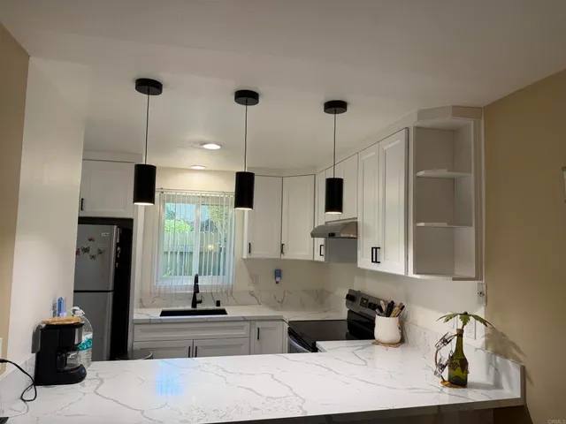 a kitchen with stainless steel appliances kitchen island granite countertop a sink and cabinets