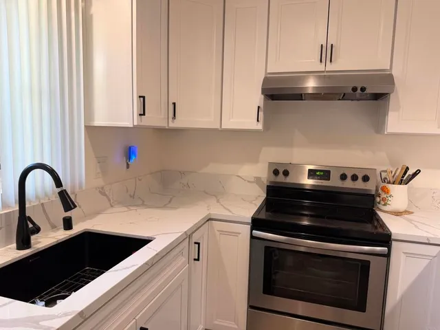 a kitchen with a stove and a sink