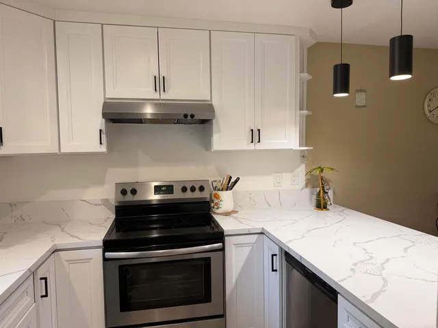 a kitchen with granite countertop a stove and a sink