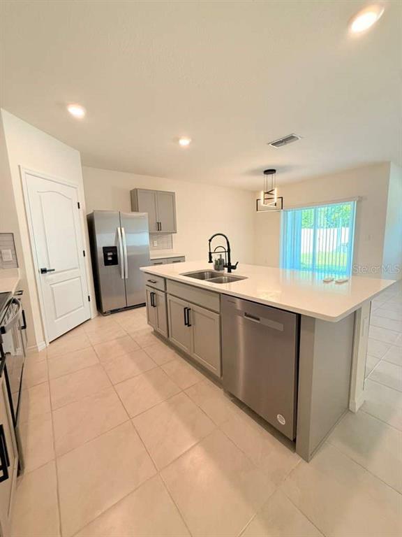 2518 Trinidad Road Haines City, FL 33844 - Photo 8 of 17 a kitchen with refrigerator and cabinets