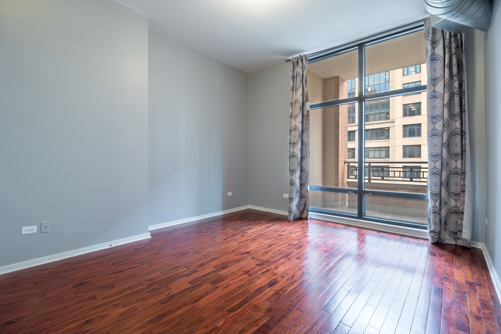 520 South State Street, Unit 1403 Chicago, IL 60605 - Photo 17 of 19 wooden floor in an empty room with a window