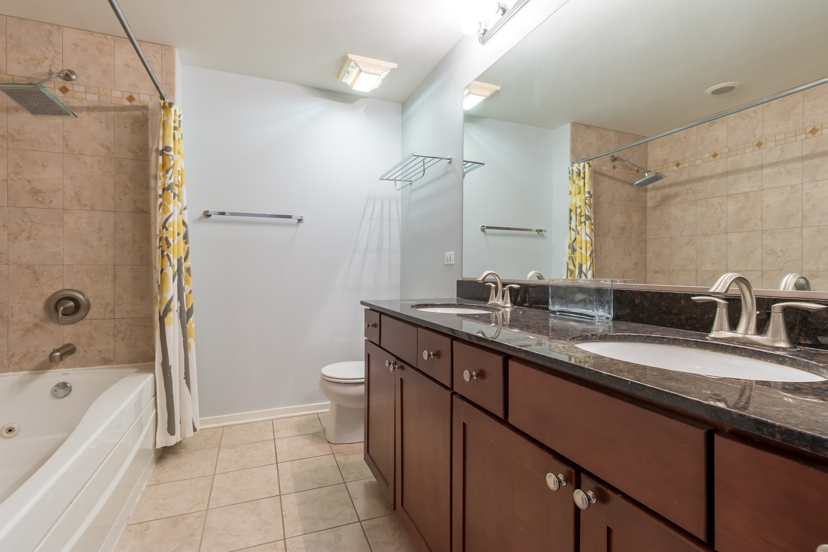 520 South State Street, Unit 1403 Chicago, IL 60605 - Photo 18 of 19 a bathroom with a granite countertop sink a toilet mirror and bathtub