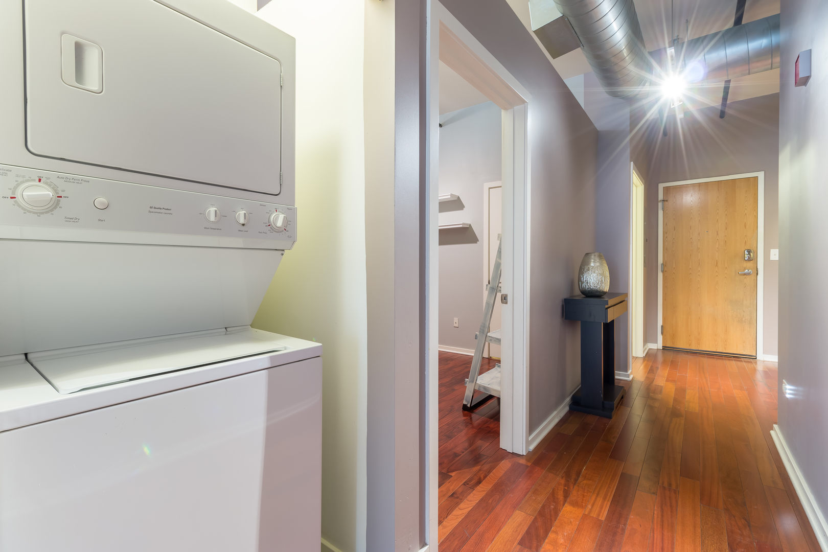 520 South State Street, Unit 1403 Chicago, IL 60605 - Photo 8 of 19 a view of washer and dryer with wooden floor