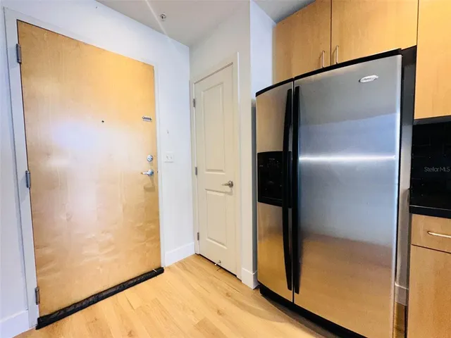 a kitchen with stainless steel appliances granite countertop a stove a sink and a refrigerator