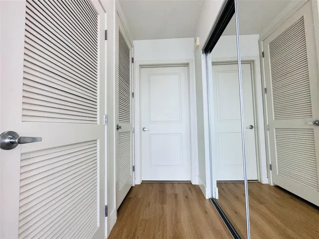 a view of a workspace with furniture and wooden floor