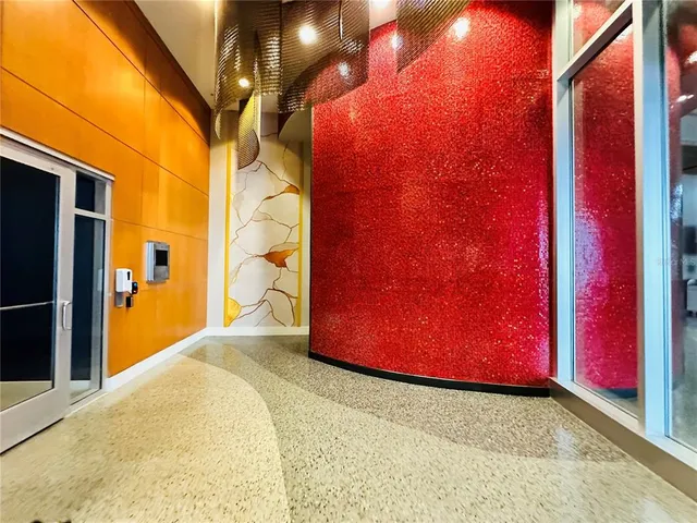 a living room with furniture a flat screen tv and a floor to ceiling window