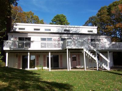66 Holly Point Road Centerville, MA 02632 - Photo 2 of 26 a front view of a building with a garden