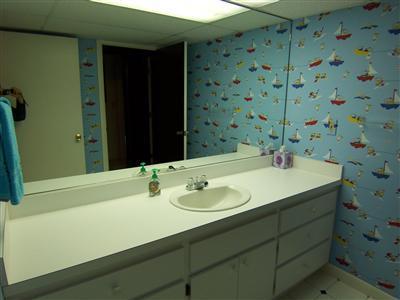 66 Holly Point Road Centerville, MA 02632 - Photo 23 of 26 a bathroom with a sink and a mirror