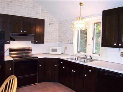 66 Holly Point Road Centerville, MA 02632 - Photo 9 of 26 a kitchen with a sink and a refrigerator